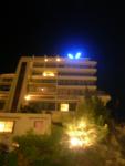 The big blue V on the Vista Palace at night